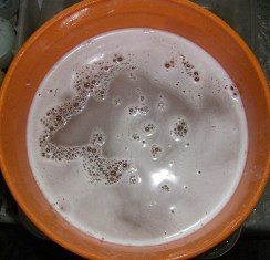 How to dip tie dye t-shirts into a soda ash water solution.