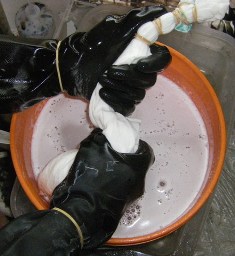 How to dip tie dye t-shirts into a soda ash water solution.