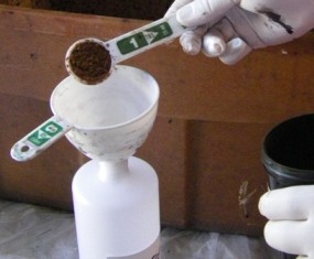 Take cap off squirt bottle and insert funel.