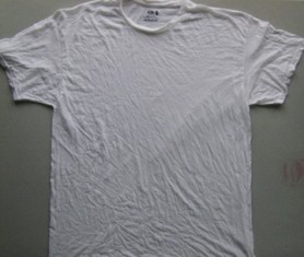 Lay wet t-shirt flat on a table.
