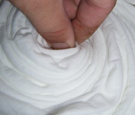Grasp the middle of the t-shirt and twist into a spiral.