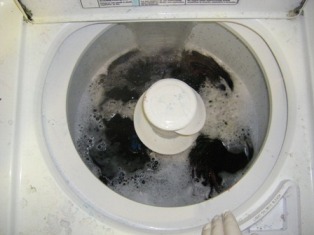 Place t-shirt in the washing machine making sure to fully submerge the entire shirt under the water.